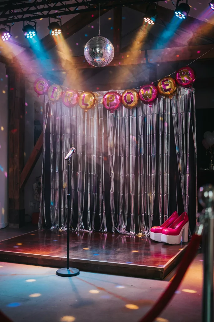 Spice Girls inspired disco dance corner with mirrored disco ball and Girl Power banner