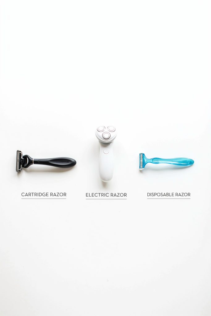 Side-by-side photo showing a cartridge razor, an electric razor, and a disposable razor clearly laid out on a clean white surface. Labels below each one.