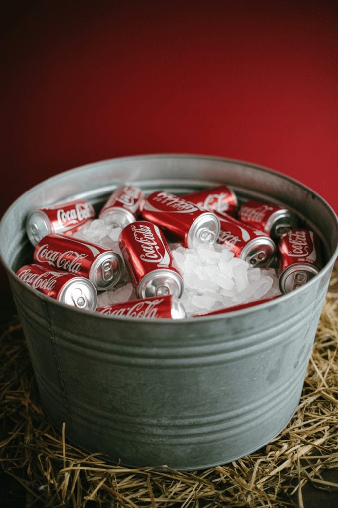 Galvanized metal tub filled with ice and canned drinks for a self-serve BBQ station