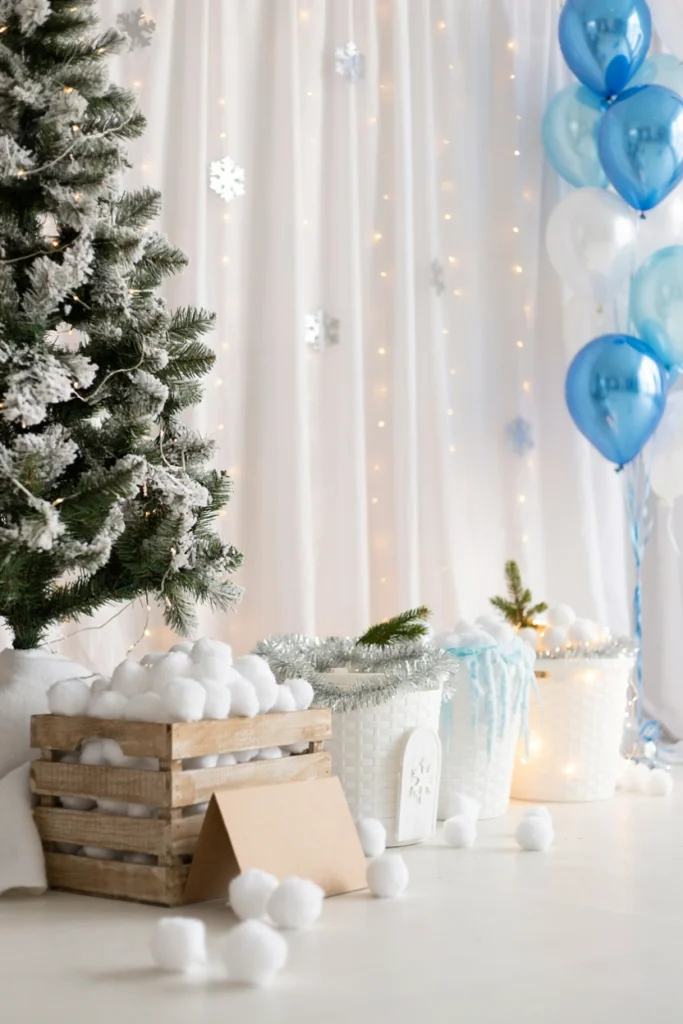 White pom-pom snowballs being tossed into laundry baskets decorated as igloos