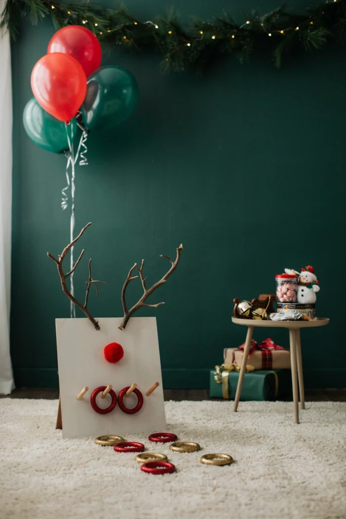 A cardboard reindeer head cutout with branch antlers while kids toss glittery rings toward it