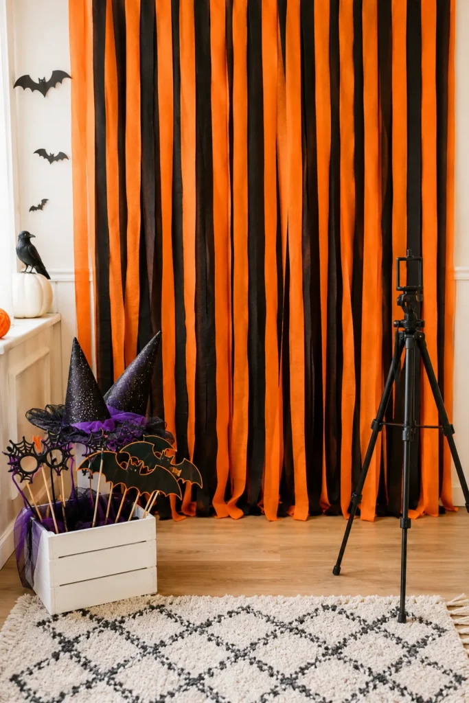 DIY Halloween photo booth with streamer backdrop and costume props
