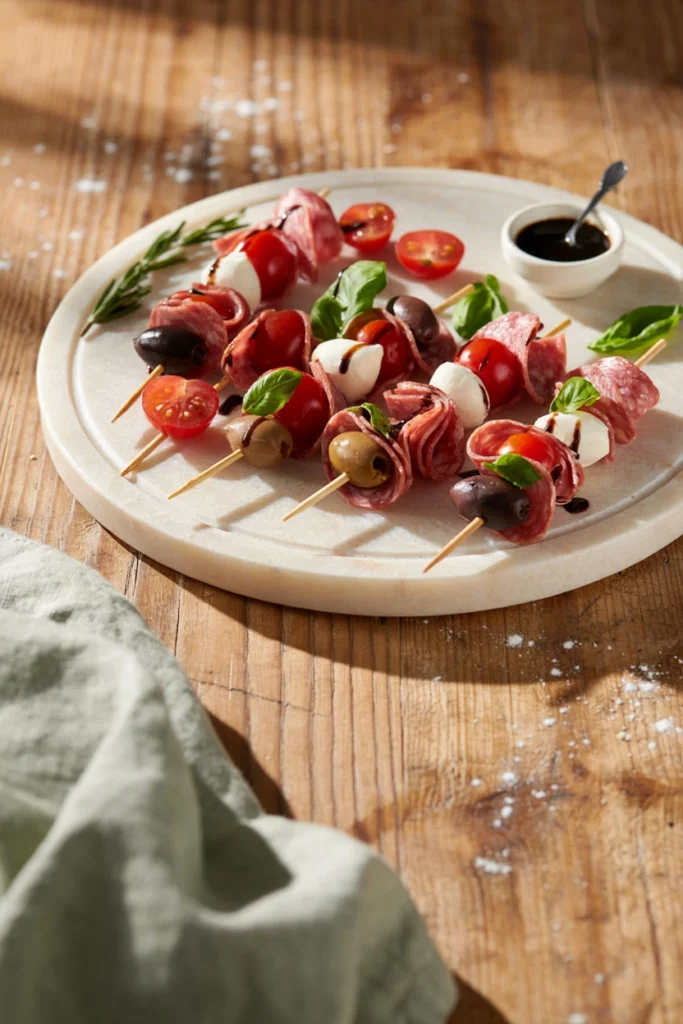 Antipasto skewers with mozzarella, salami, olives, and cherry tomatoes