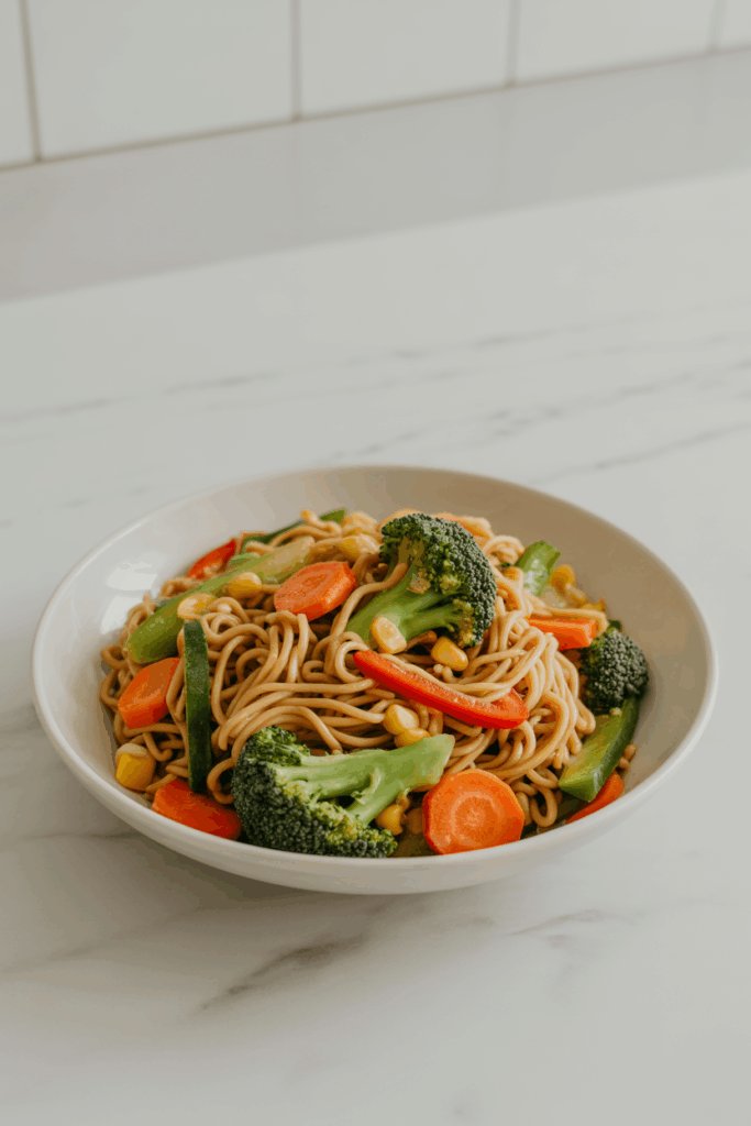 Modern bowl of vibrant vegetable ramen with greens and chili oil, bright clean table setting.