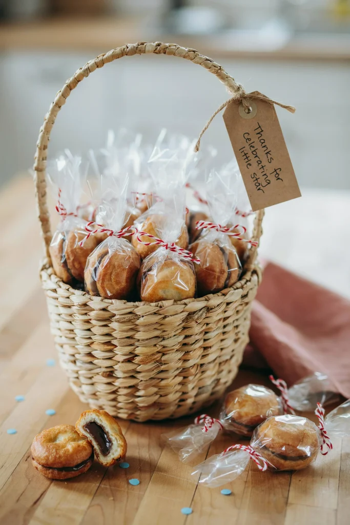 Individually wrapped mini moon pies stacked in a basket, tagged with a small "Thanks for celebrating our little star" label.