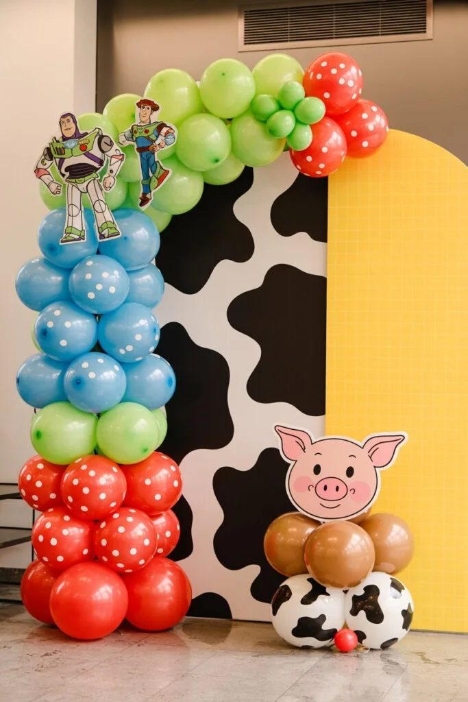 Toy Story baby shower decor with primary color balloon arch