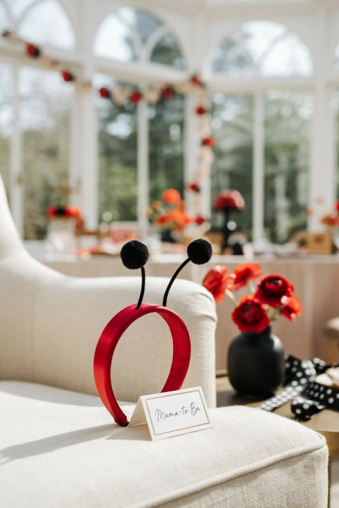 Red glitter ladybug antenna headband with black pom-poms for mom-to-be