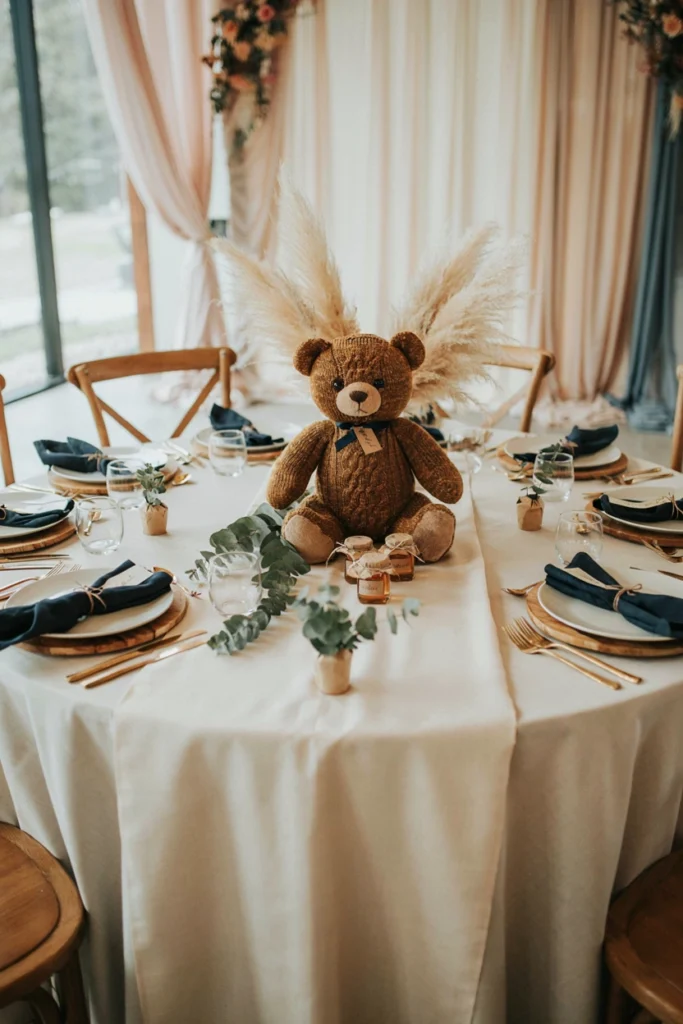 Chunky knit brown bear centerpiece surrounded by pampas grass and navy pillar candles