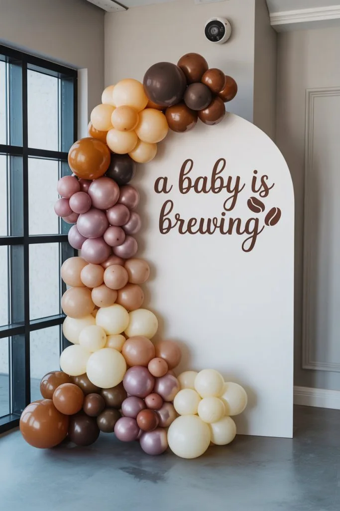 Layered coffee tone balloon backdrop in beige caramel and brown for a baby shower