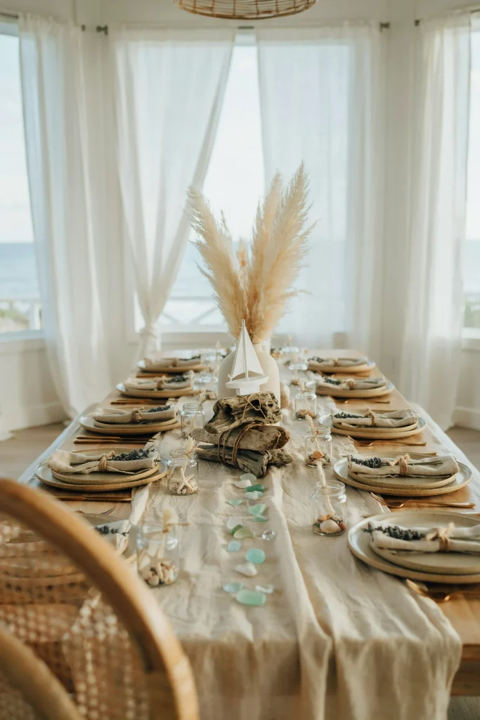 Coastal baby shower dessert table with driftwood and linen decor