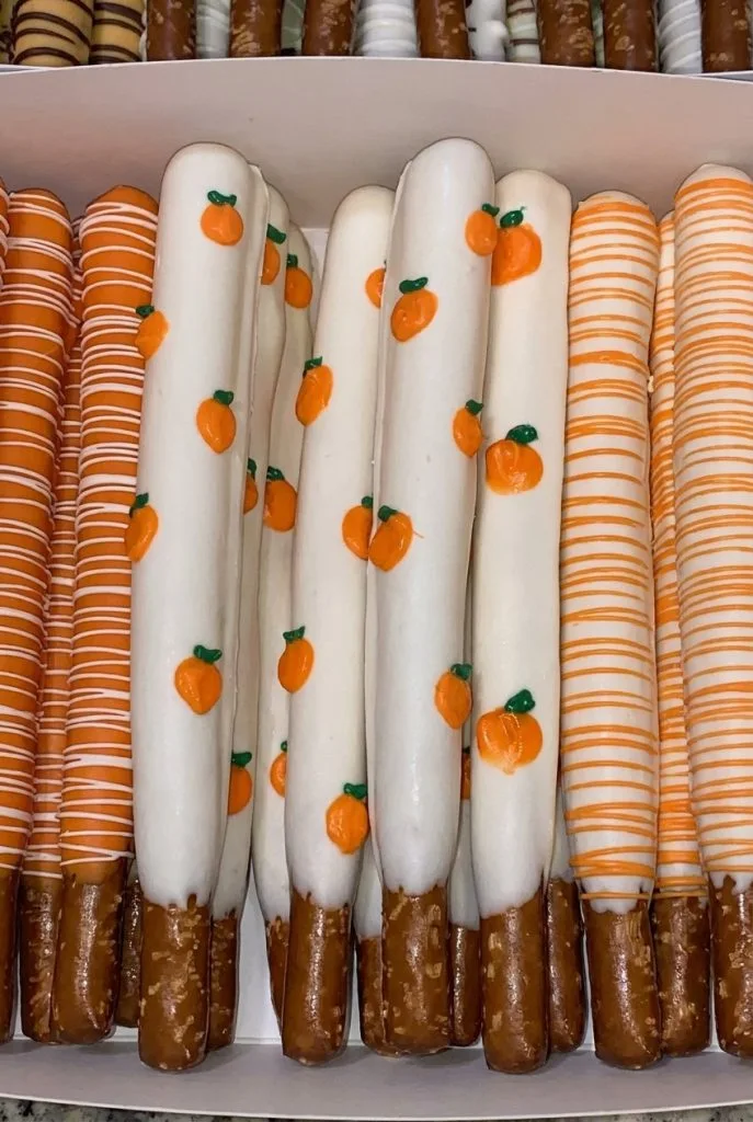 White chocolate covered pretzel rods with pumpkin details