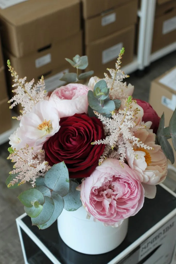 Blush and burgundy floral centerpiece for a fall baby shower