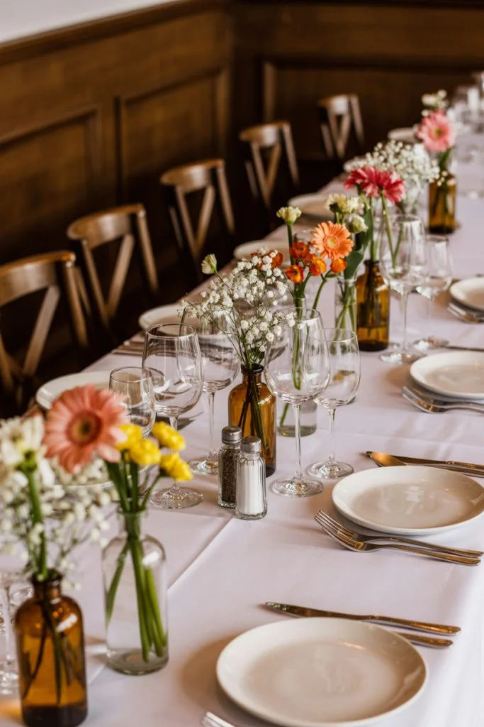 Glass bottle bud vase centerpieces on a fall baby shower table