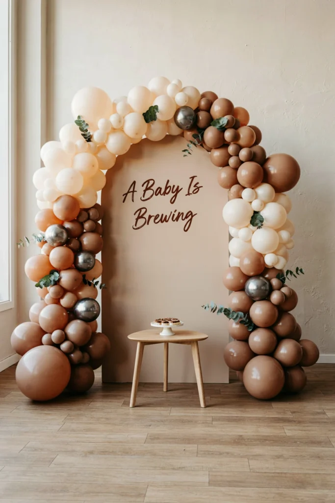 Layered coffee tone balloon backdrop in beige, caramel and brown for a baby shower