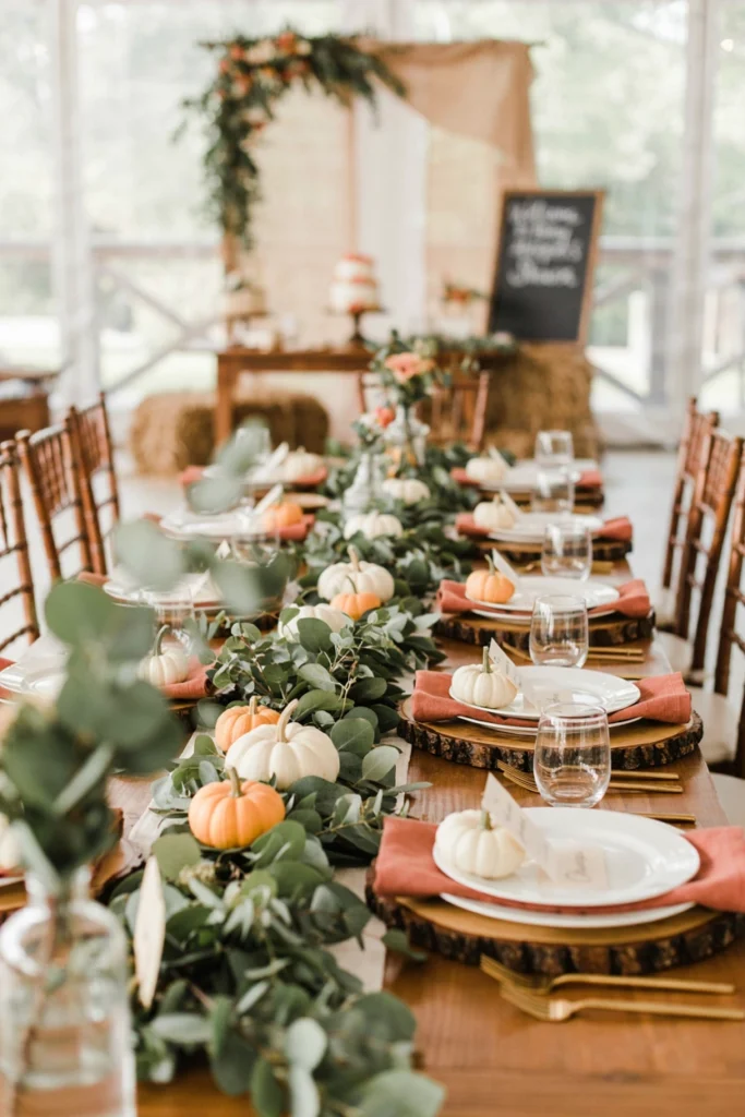 Individual wood slice place settings topped with tiny pumpkins and name cards