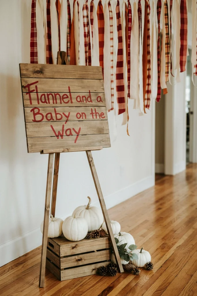 A wooden welcome sign encouraging guests to wear flannel, set against a backdrop of hanging plaid ribbon