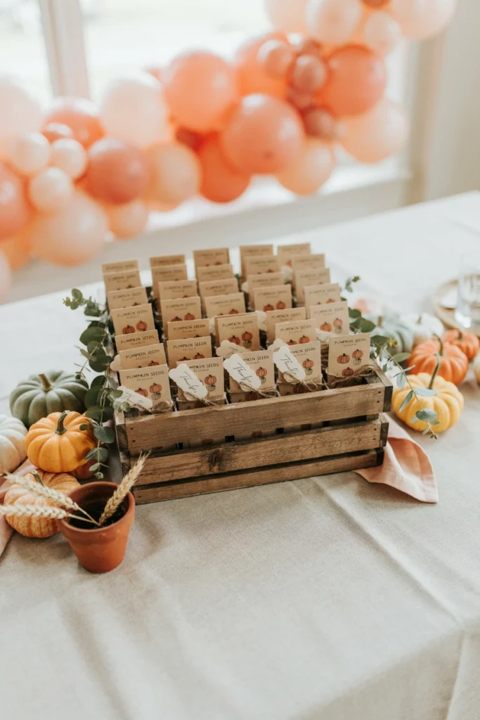 Small pumpkin seed packet favors tied with twine for a fall baby shower