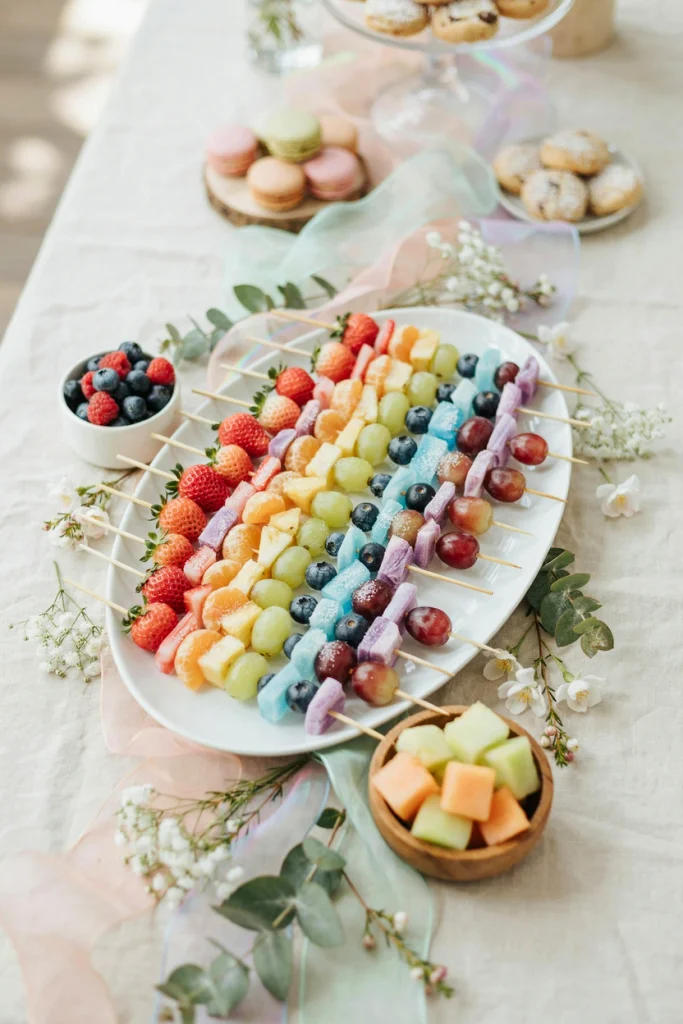 Fruit skewers dusted with a gradient of pastel sugar colors