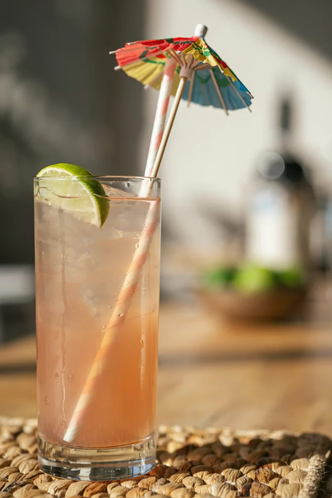 Close-up of a drink topped with a colorful paper umbrella straw