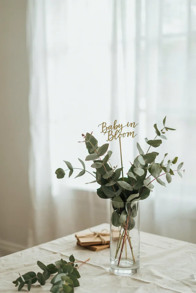 Gold Baby in Bloom script centerpiece sticks in a vase