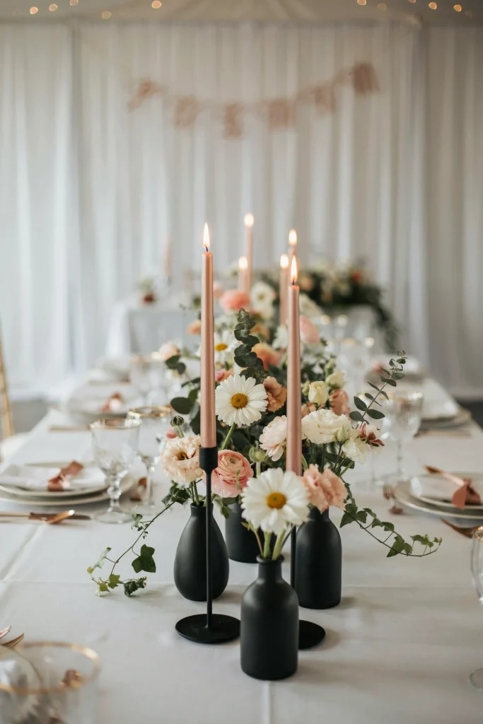 Ivory and rose gold daisy arrangements in black vases