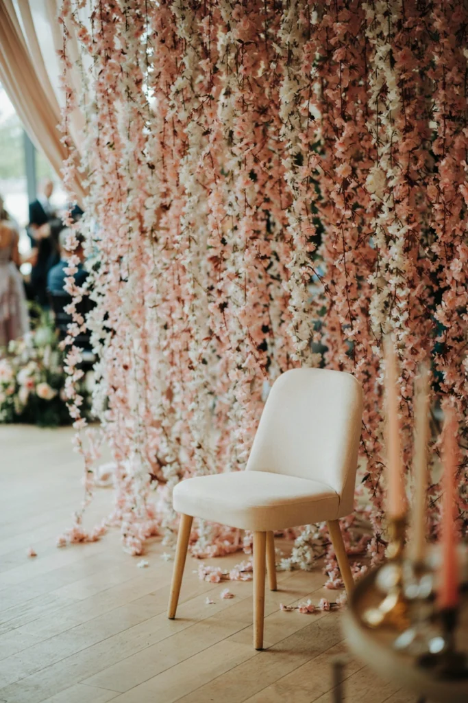 Cascading pink flower curtain backdrop at a sugar plum baby shower