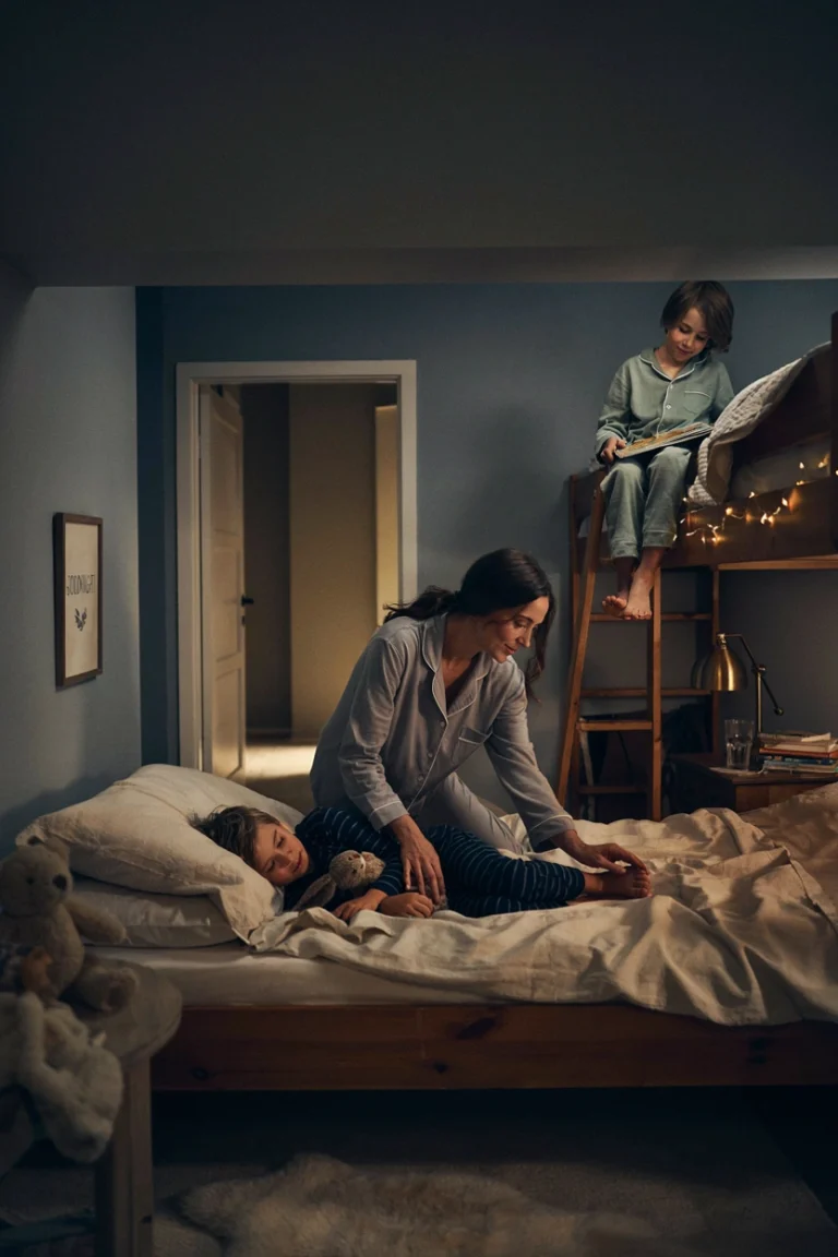 A calm mom with two kids at bedtime, transitioning smoothly into bed without negotiation. Warm, peaceful lighting