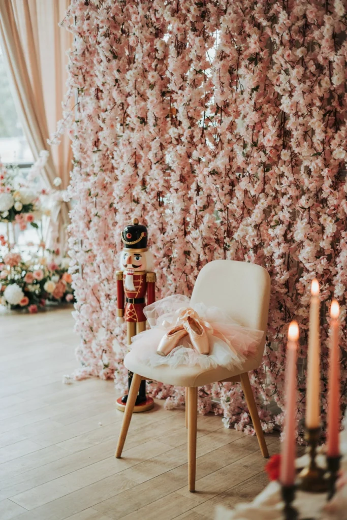 Cascading pink flower curtain backdrop at a sugar plum baby shower