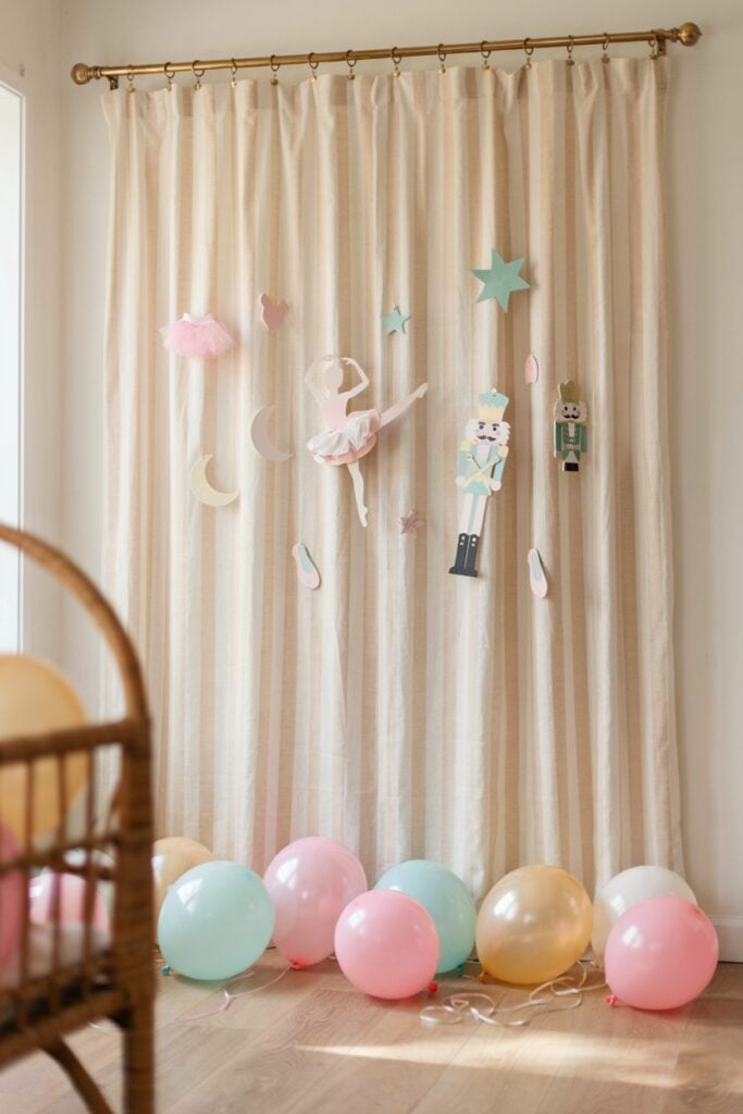 Budget-friendly DIY pink and cream striped fabric baby shower backdrop