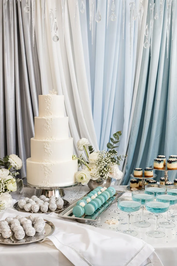 Silver and ice blue pleated dessert table backdrop for a winter baby shower