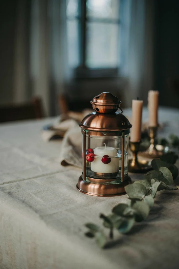 Copper lantern with a floating candle for a fall baby shower centerpiece
