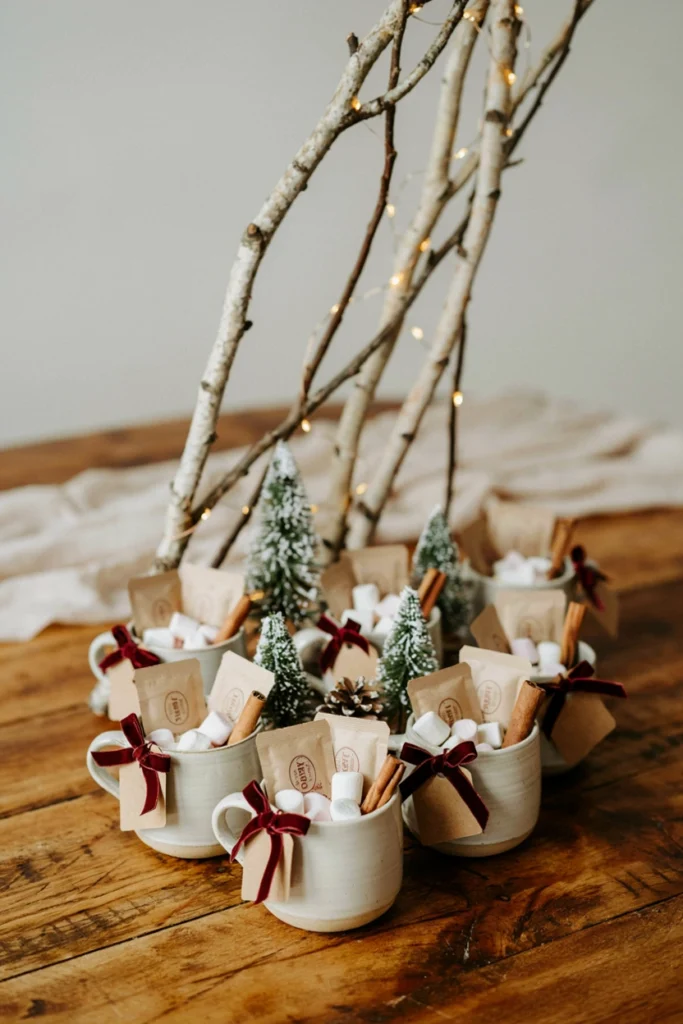 Take-home mug favor station tagged with village-themed notes for baby shower guests