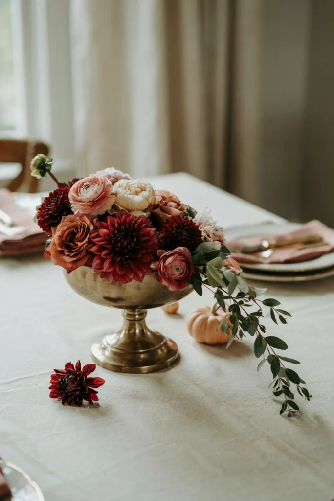 Cascading floral arrangement with blush pumpkins for an elevated fall baby shower centerpiece