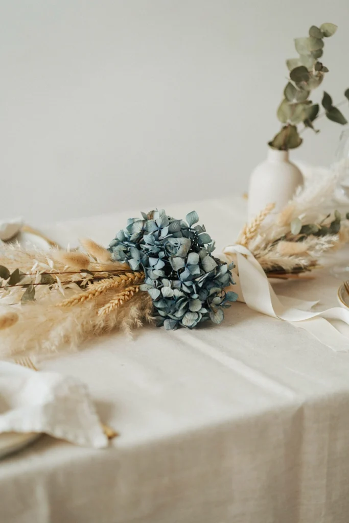 Dried hydrangea and wheat sheaf bundle centerpiece for a fall baby shower