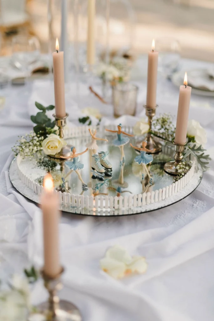Miniature ice rink centerpiece with figurine skaters on a mirror tray