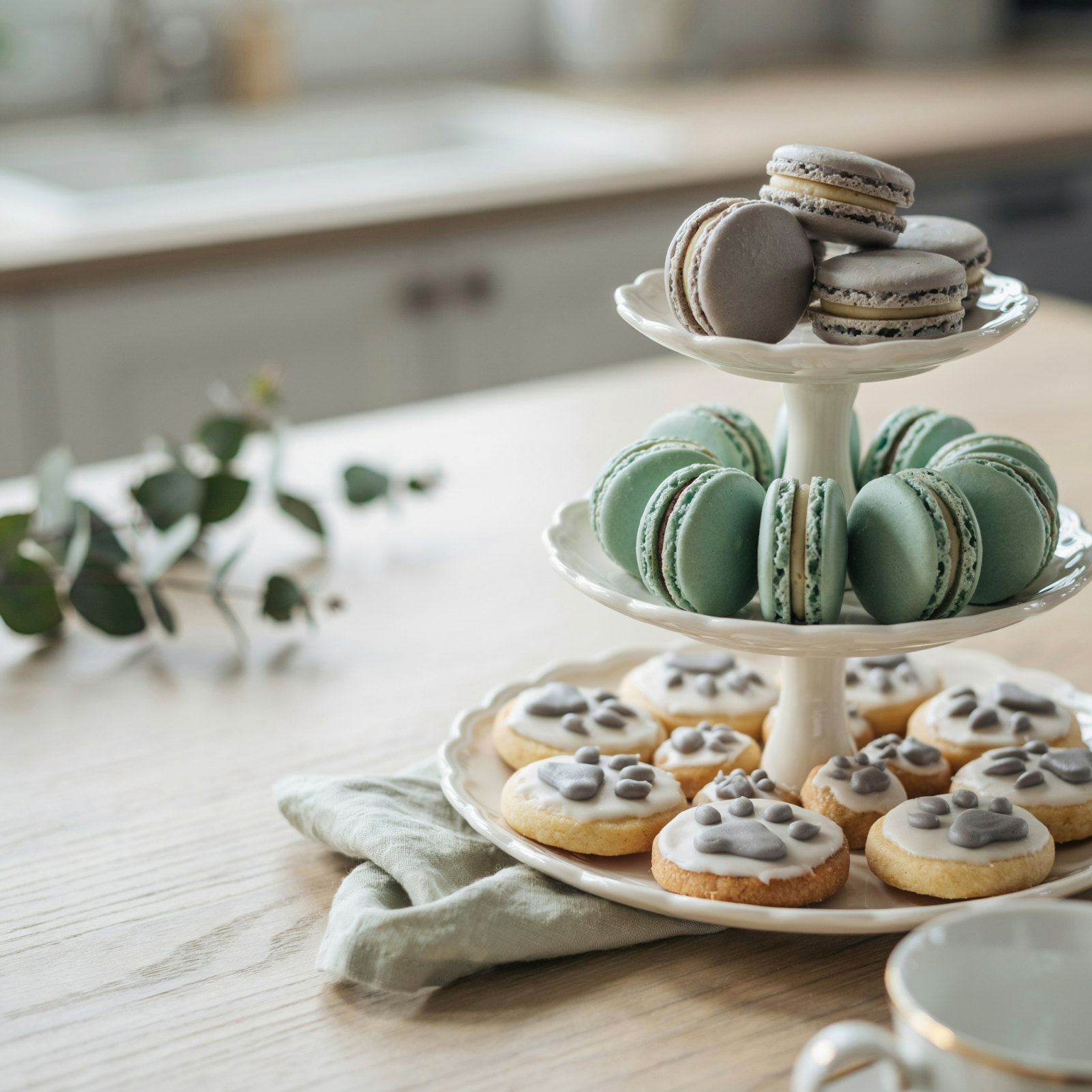 Paw print cookie and macaron tower in gray and mint tones