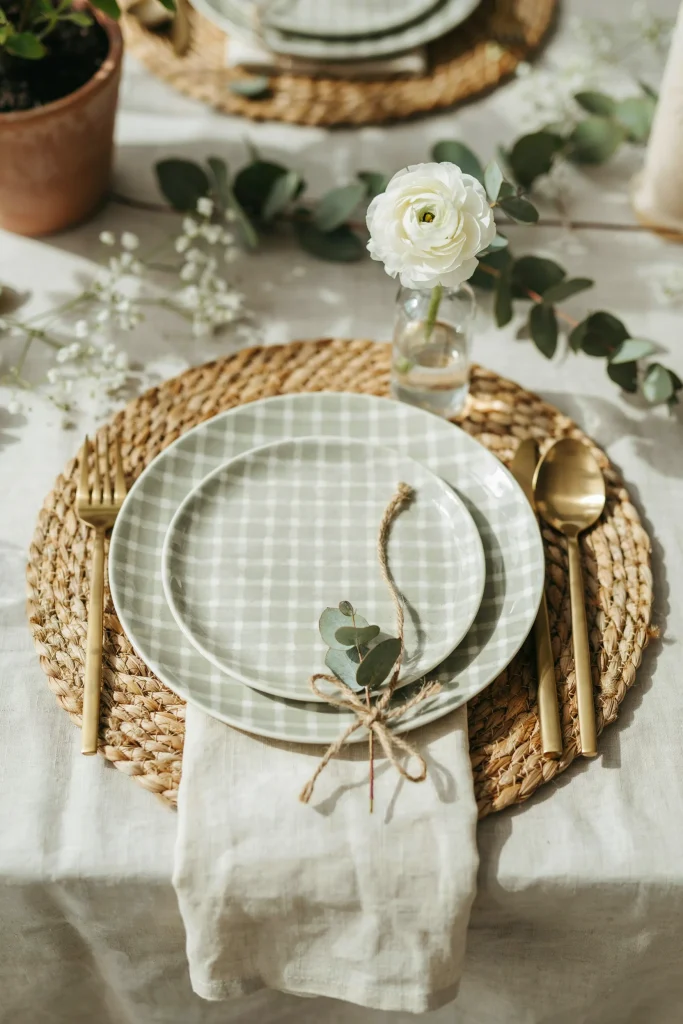 Sage green gingham table setting with plates, napkins, and cutlery