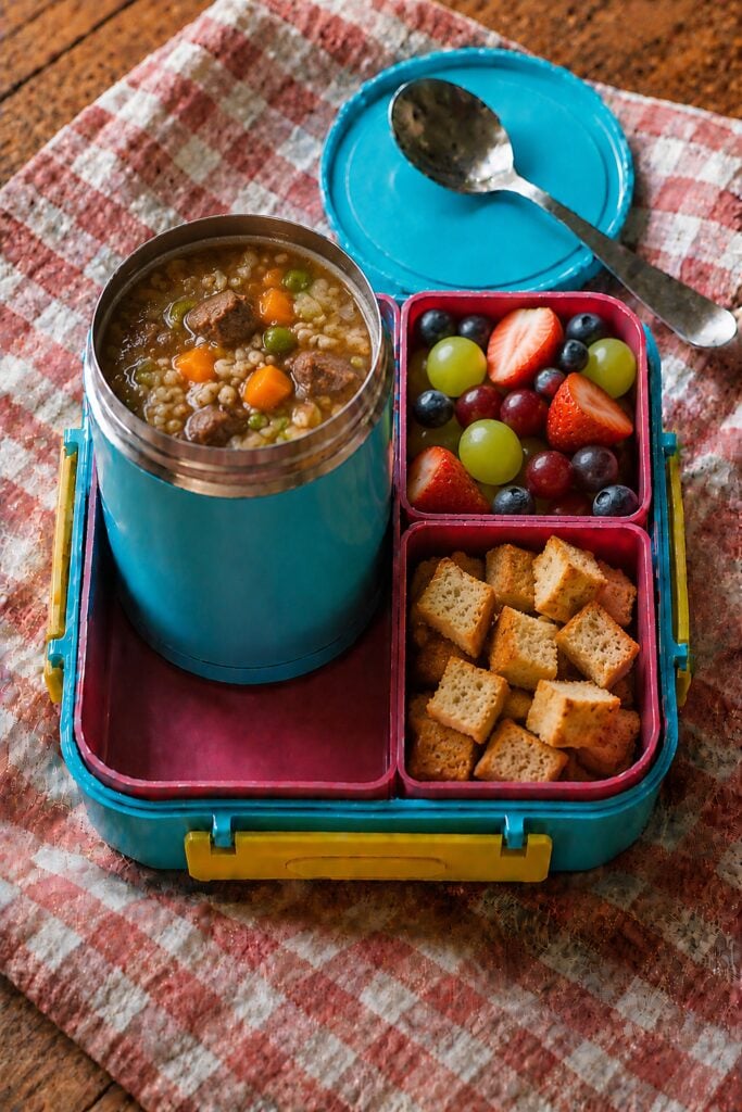 Hearty beef barley soup with vegetables in a thermos
