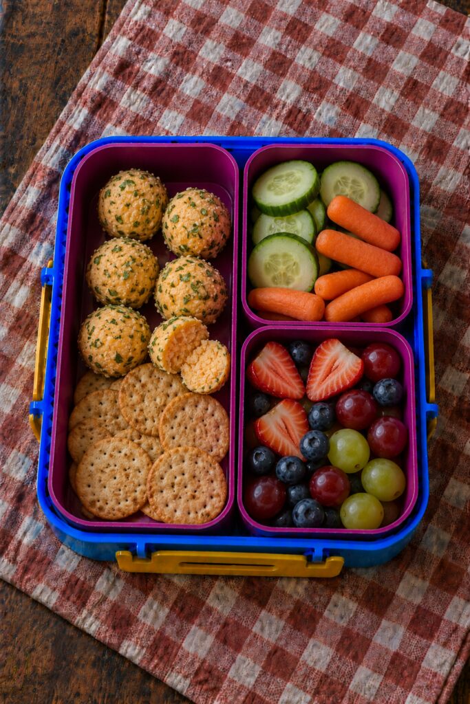 Small cheese balls rolled in herbs with crackers