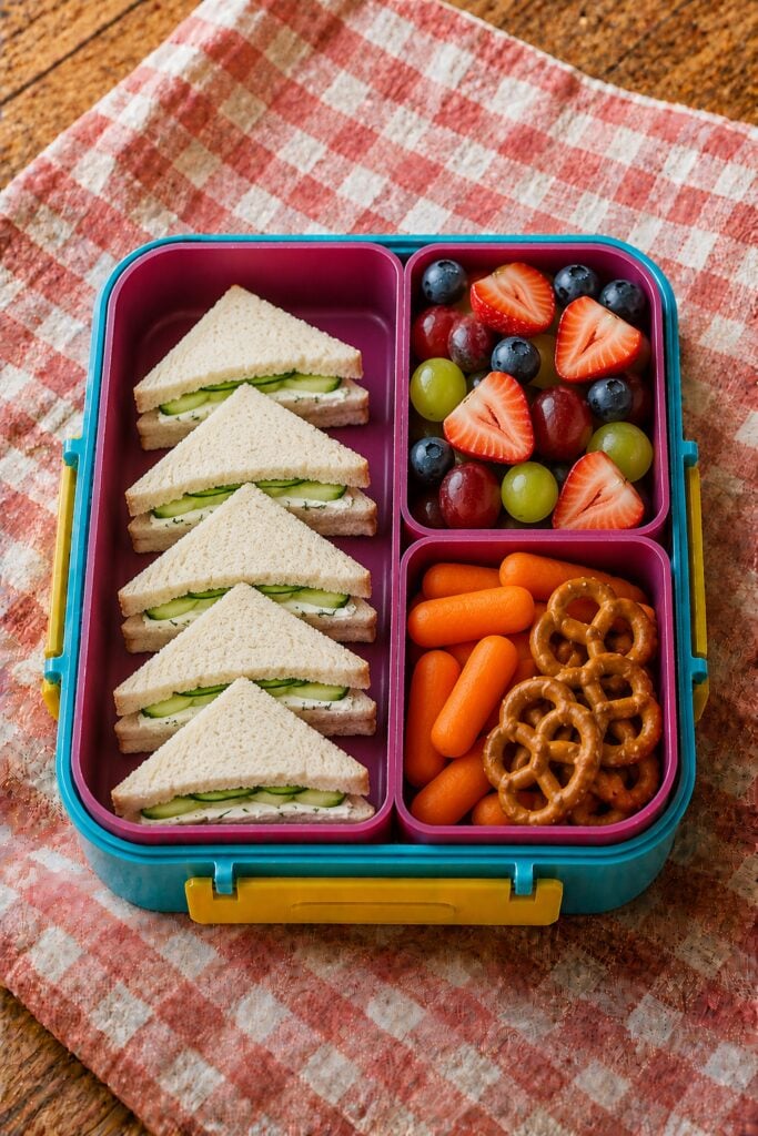 Small triangle sandwiches with cucumber peeking out