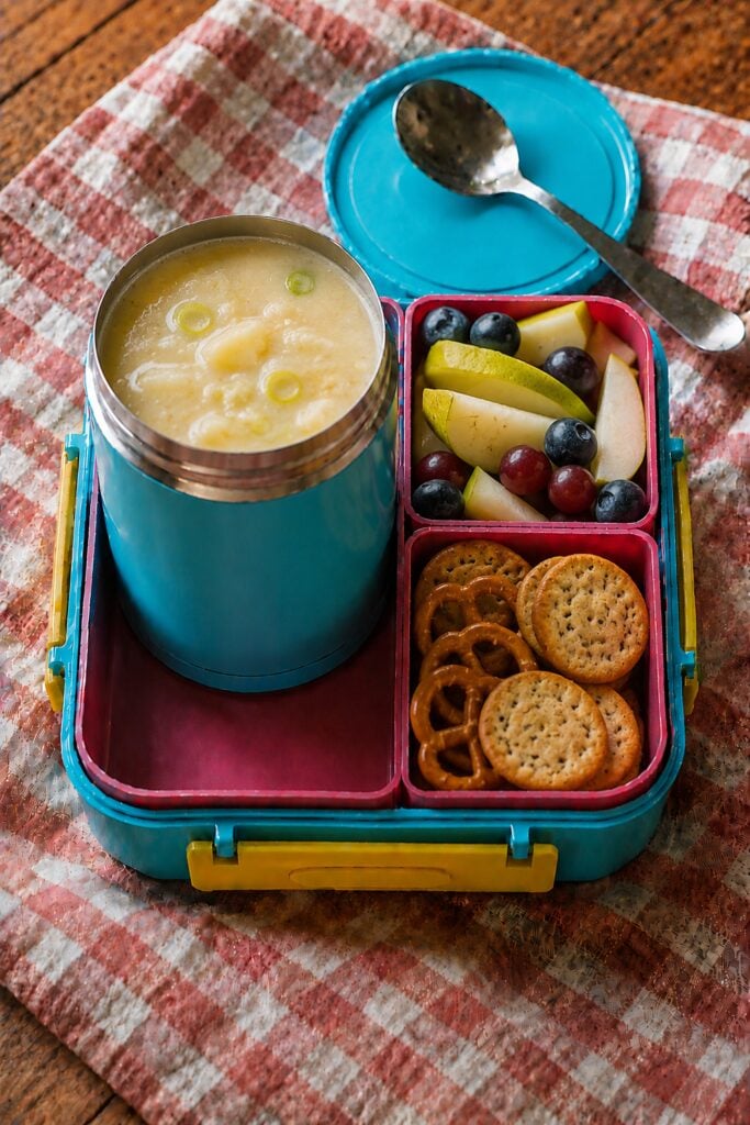 Pale green potato leek soup in a thermos