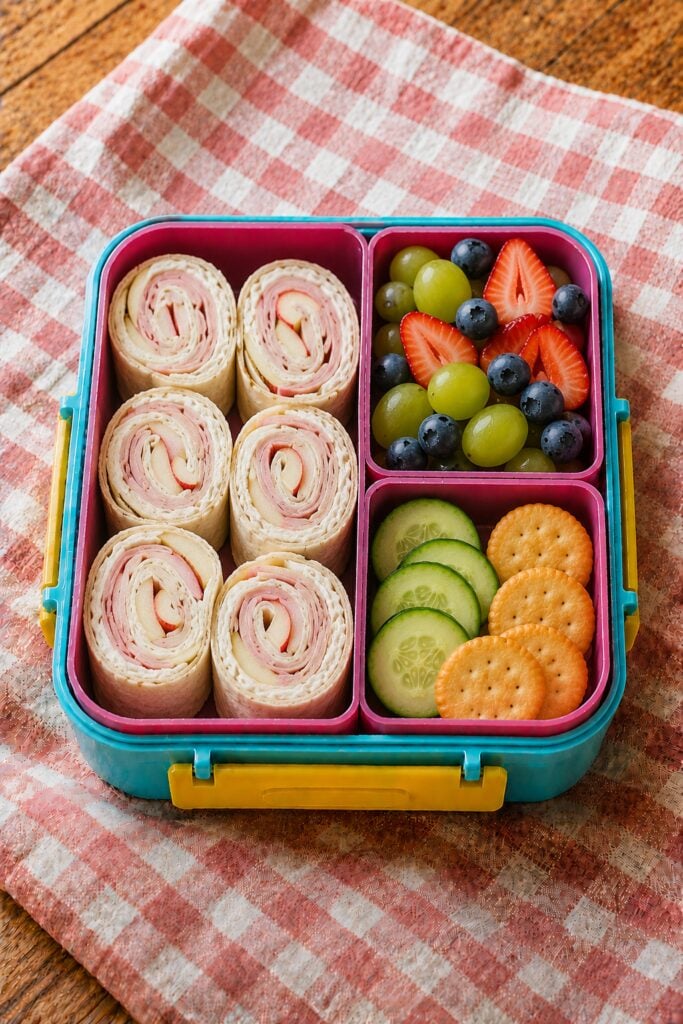 Sliced ham and apple pinwheels on a tortilla