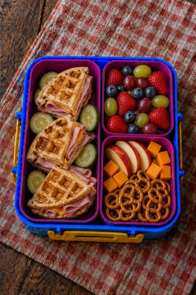 Waffle sandwich with ham and melted cheese