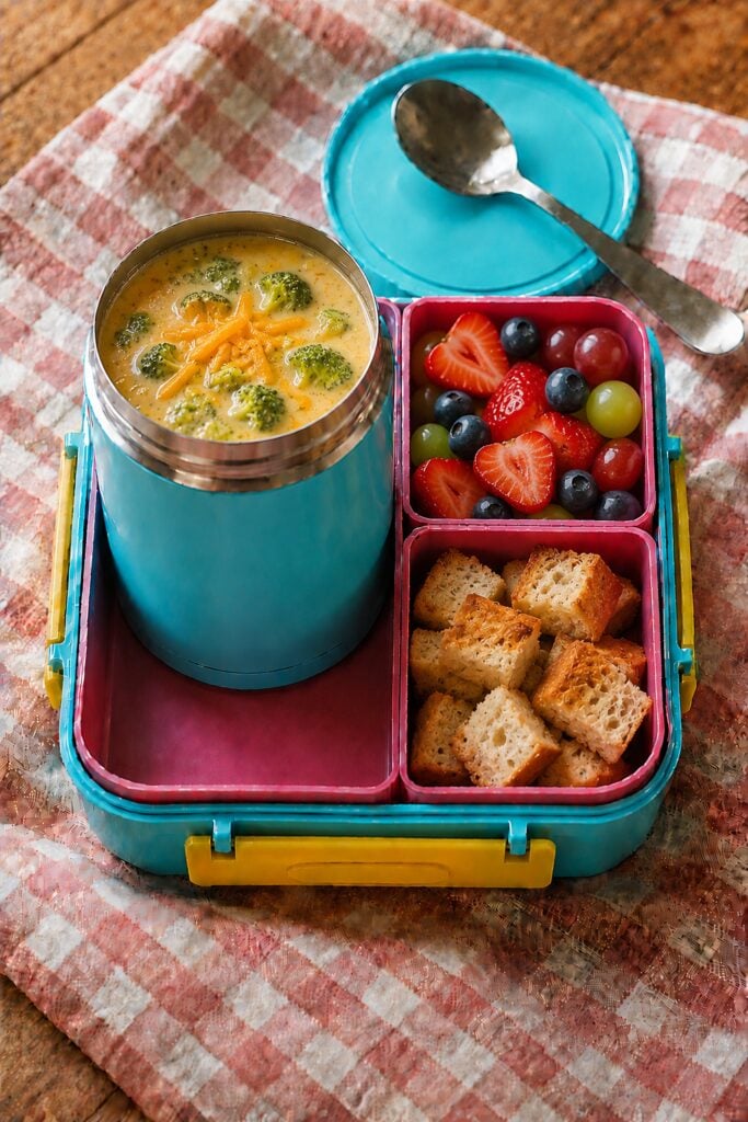 Bright green broccoli cheddar soup in a thermos