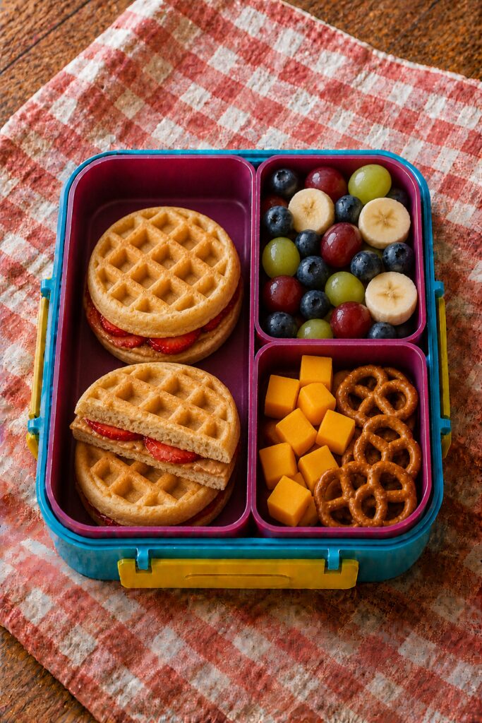 Waffle sandwich with peanut butter and sliced strawberries