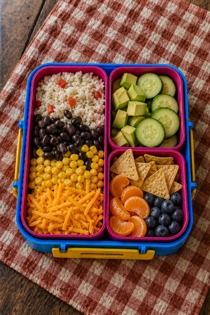 Rice, beans, and cheese layered in a compartment box