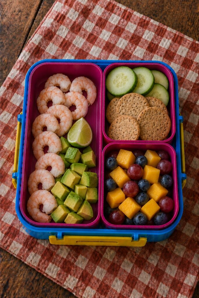 Cooked shrimp and diced avocado with lime wedge