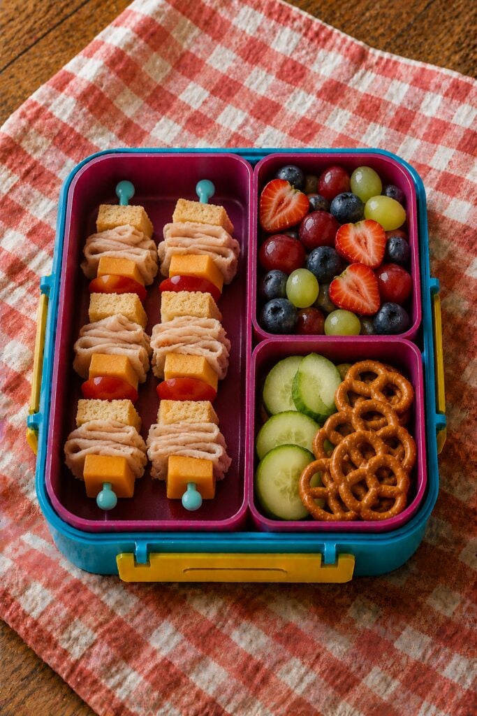 Skewers threaded with turkey, cheese, and tomato