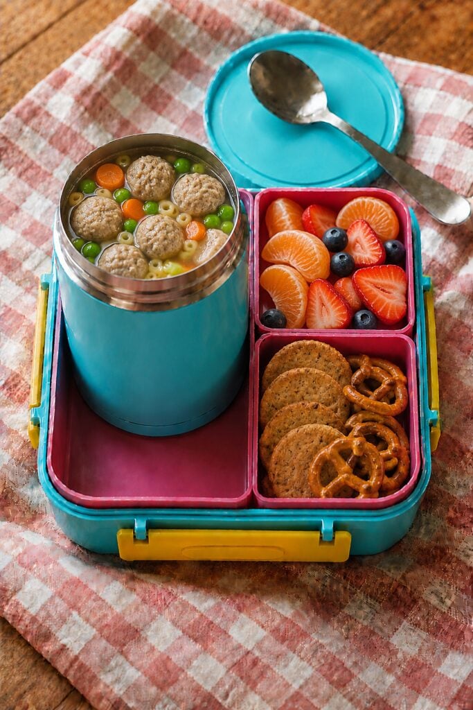 Small turkey meatballs floating with vegetables in broth