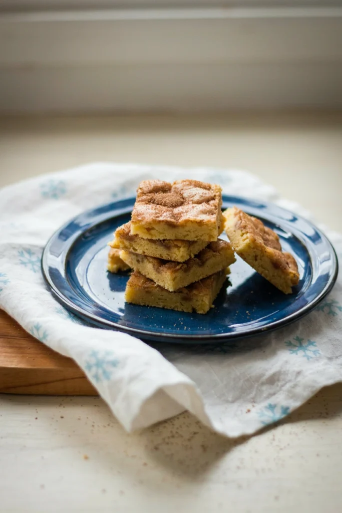 Pan of golden snickerdoodle blondies dusted with cinnamon sugar